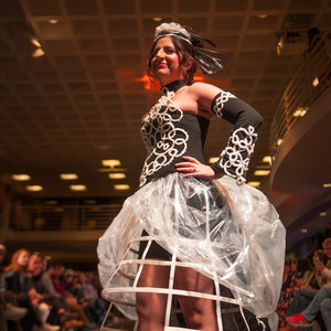 Marcy Gillis sporting ''Woven'', a dress designed by Julie Kim and made by weaving and tying a series of knots from plastic threads, which were created by twisting together thin strips of trash bags at The Trashion Show 2017, organized by UA committee on sustainability Saturday, Dec. 1. Judges awarded ''Woven'' the first place in the show